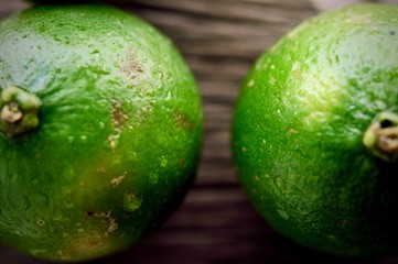 limes slices on wooden table. Detox diet, fresh lime Background, Close up shot, fruit macro photography