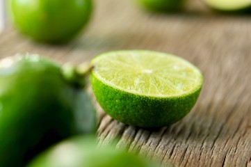 limes slices on wooden table. Detox diet, fresh lime Background, Close up shot, fruit macro photography