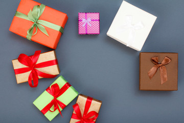 Gift boxes with red and green ribbons on gray background.