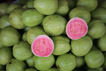Pink fruit on green background