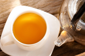 tea cup wih tea pot on wood,top view