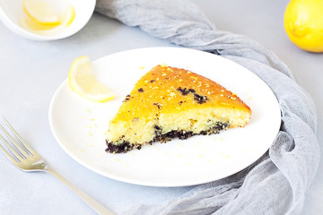 Composition with tasty lemon poppy pie on grey concrete background