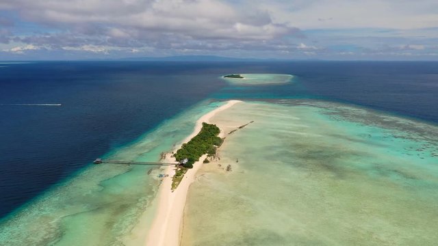 Aerial panoramic view of sandy islet Timba Timba, turquoise crystal clear waters of Celebes Sea, white sand beaches and coral reefs  - landscape panorama of Borneo island, Malaysia, Pacific Ocean