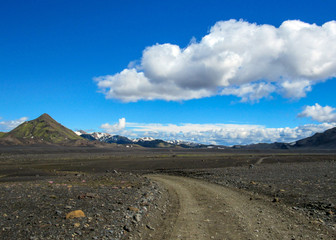 Walking path throw volcanic black sand desert landscape, Laugavegur Trail from Thorsmork to Landmannalaugar, Highlands of Iceland