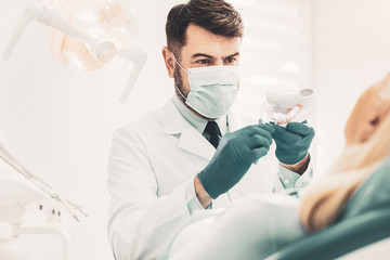 Fototapeta na wymiar Stomatologist showing dental mockup