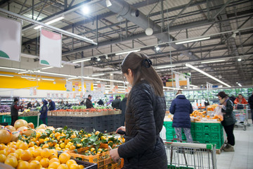 Woman choosing fruits on counter
