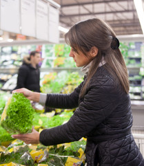 Woman choosing vegetables on counter