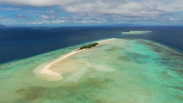 Aerial panoramic view of sandy islet Timba Timba, turquoise crystal clear waters of Celebes Sea, white sand beaches and coral reefs  - landscape panorama of Borneo island, Malaysia, Pacific Ocean