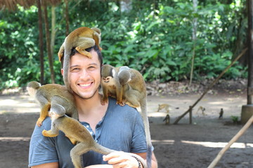 Man and Titi monkeys in the Amazon region 