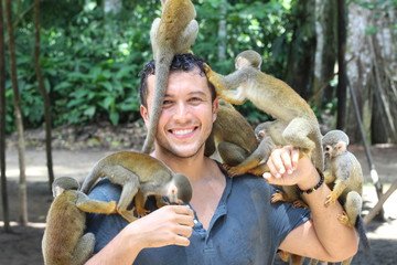 Fototapeta premium Beautiful monkeys interacting with a human