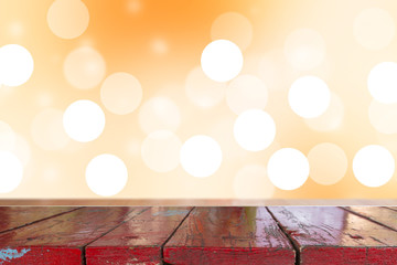 Wooden desk with Gradient Abstract Blurred orange tone lights background