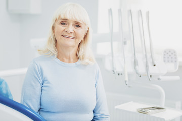 Charming senior woman paying visit to dentist