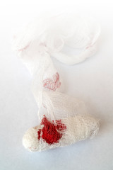 Red blood on a white bandage.