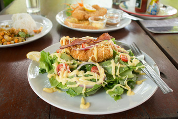 Battered fish steak with salad and vegetable