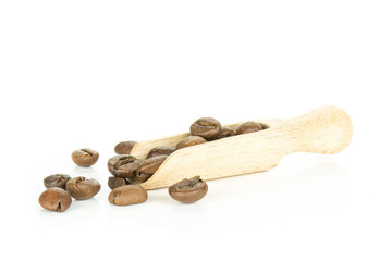Lot of whole dark brown coffee beans sweet arabica variety with wooden scoop isolated on white background
