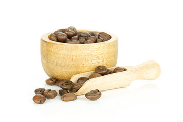 Lot of whole dark brown coffee beans sweet arabica variety in a scoop with wooden bowl isolated on white background