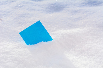 blank blue sticker on the snow. Christmas and New Year holidays concept