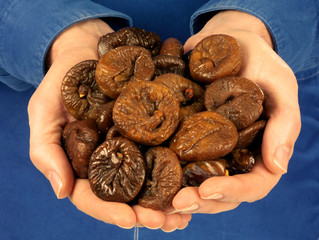 MAN HOLDING DRIED FIGS