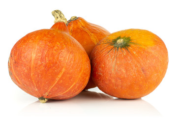 Group of three whole raw fresh red kuri pumpkin hokkaido variety isolated on white background