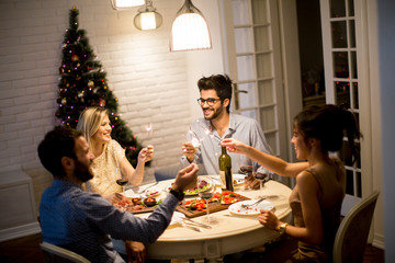 Friends celebrating Christmas or New Year eve at home