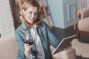 Cheerful positive woman enjoying wine