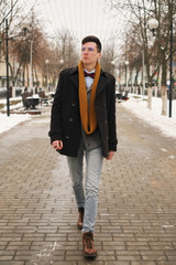 Young man with a urban look in city. hipster man in the city winter