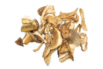 Lot of slices of dry brown mushroom boletus edulis variety heap flatlay isolated on white background