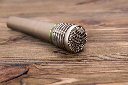 music microphone on wooden background. sound of music, singing.