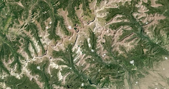 Vertical aerial ascent through light falling snow, over Uinta mountains, Utah. Elements of this image furnished by NASA. 