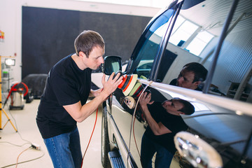 Polishing the car body.