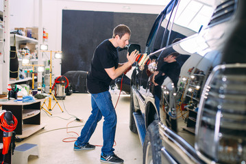 Polishing the car body.