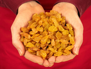MAN HOLDING GOLDEN RAISINS