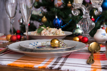 festive table set, plates, fork, Olivier salad, Christmas balls, napkins, food, new year, Christmas, glasses, Christmas tree, candle holder,