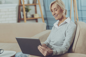 Elderly lady sitting with laptop