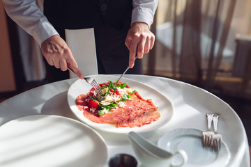 Red beef carpaccio in a white plate,