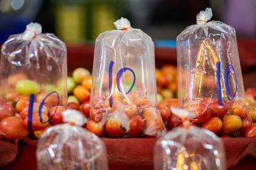 Fresh tomatoes in the plastic bag for selling