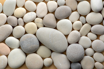 Fototapeta na wymiar Group of white and grey pebbles, one by ony, simplicity stone background, flat lay texture in daylight