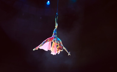 Performance of the girl aerial acrobat in the circus.