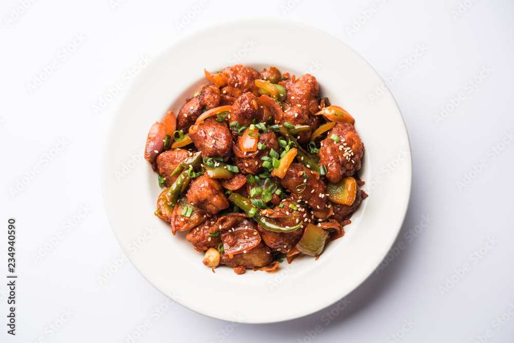 Canvas Prints Indian Chilli Chicken dry, served in a plate over moody background. Selective focus