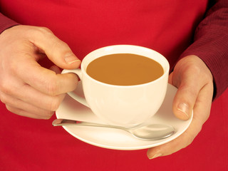 MAN HOLDING CUP OF COFFEE WITH MILK