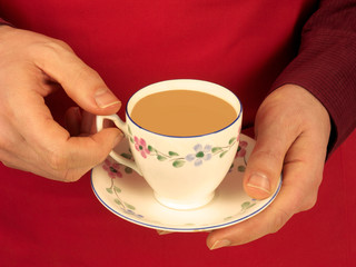 MAN HOLDING CUP OF TEA