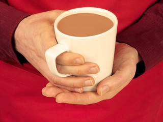 MAN HOLDING MUG OF OVALTINE