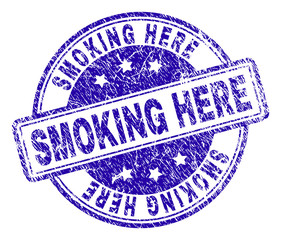 SMOKING HERE stamp seal imprint with grunge texture. Designed with rounded rectangles and circles. Blue vector rubber print of SMOKING HERE label with scratched texture.