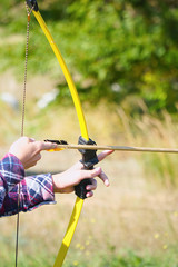 Hand holds archery and arrow