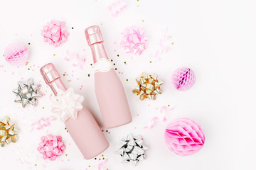 Pale Pink Mini bottles of champagne with confetti and tinsel. Flat lay. New year/Christmas celebration or wedding  concept theme. Flat lay, top view