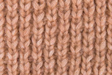 Large knitted fabric. Figure pigtail knitted fabric. Texture of knitted fabric closeup.