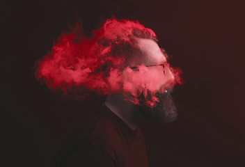 Concept. Smoke enveloped the head man. Portrait of a Bearded, stylish man with smoke. Secondhand smoke.