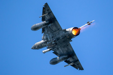 Armed fighter jet plane in flight