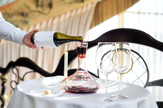 A Sommelier Pouring Red Wine Into Decanter