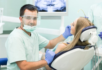 Fototapeta premium Doctor Dentist with an assistant work in a dental clinic.